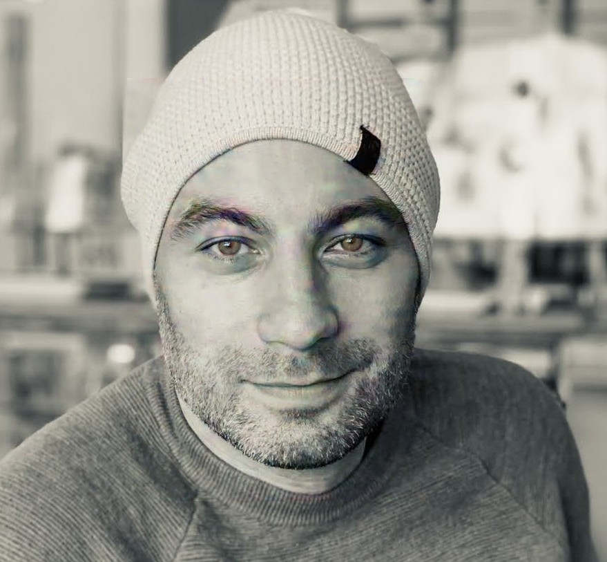 Black and white portrait of Manny in a beanie
